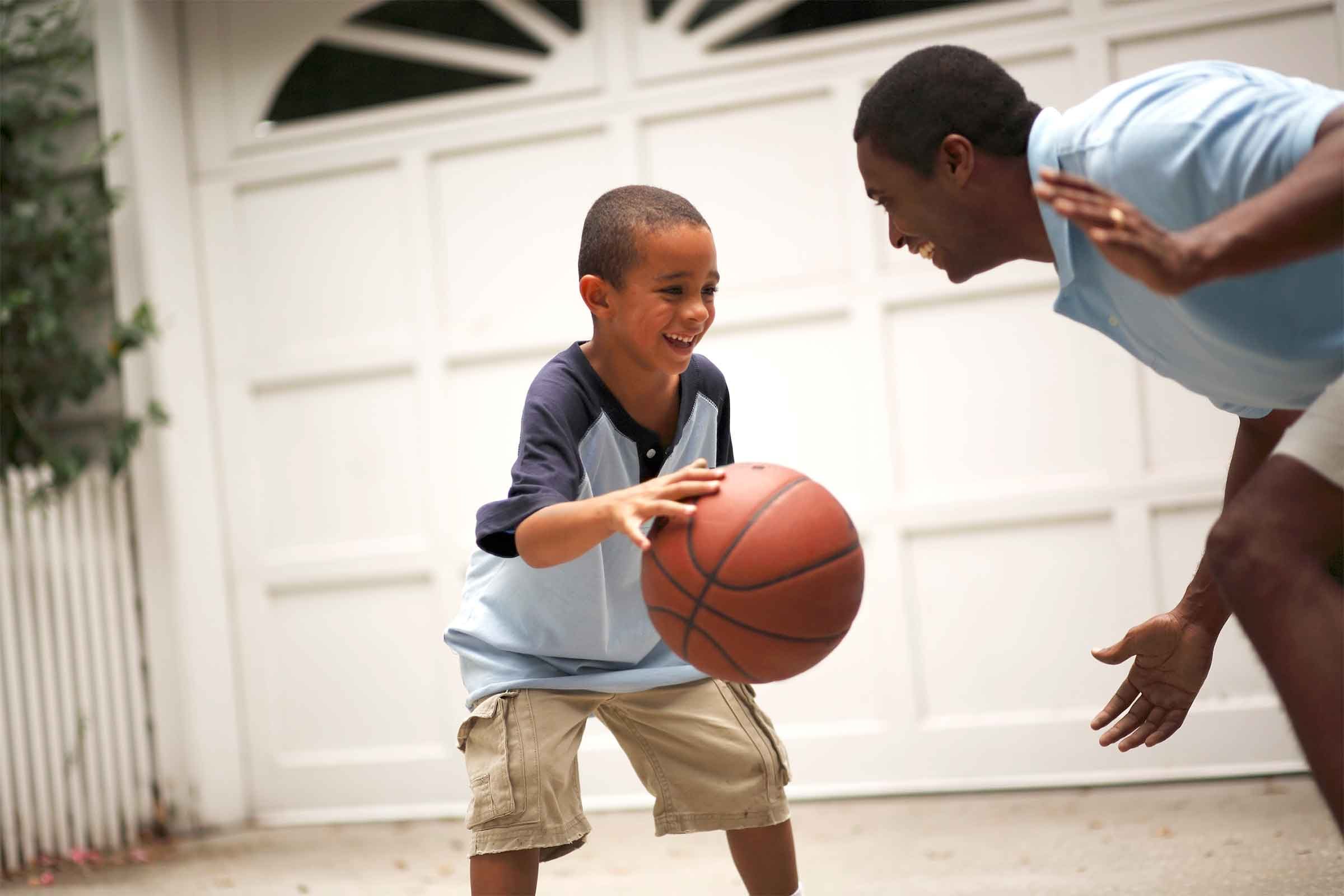 father and son playing basketball