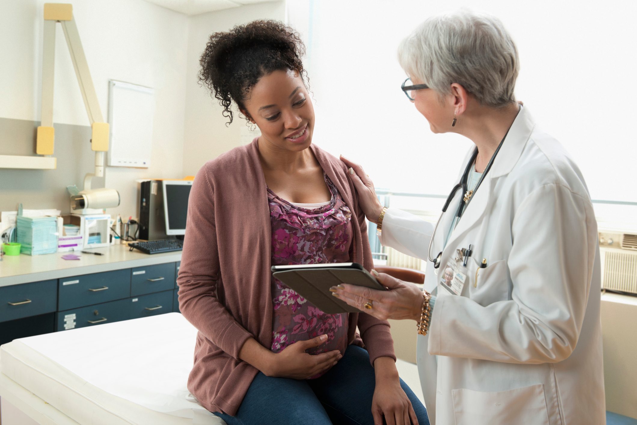pregnant woman talking with doctor