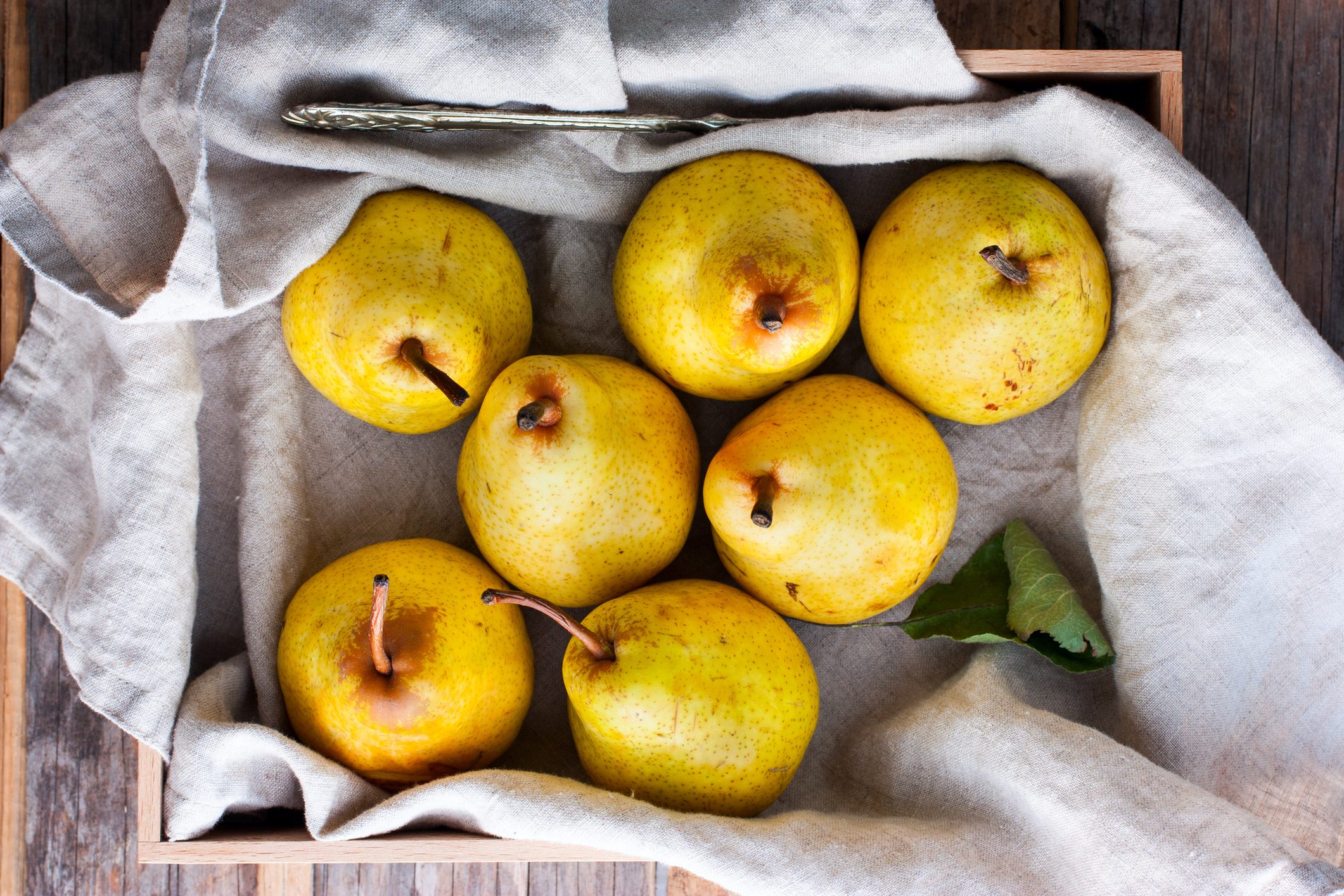 Chopped fresh yellow pear on a wooden board, top view, selective focus Fruit background.