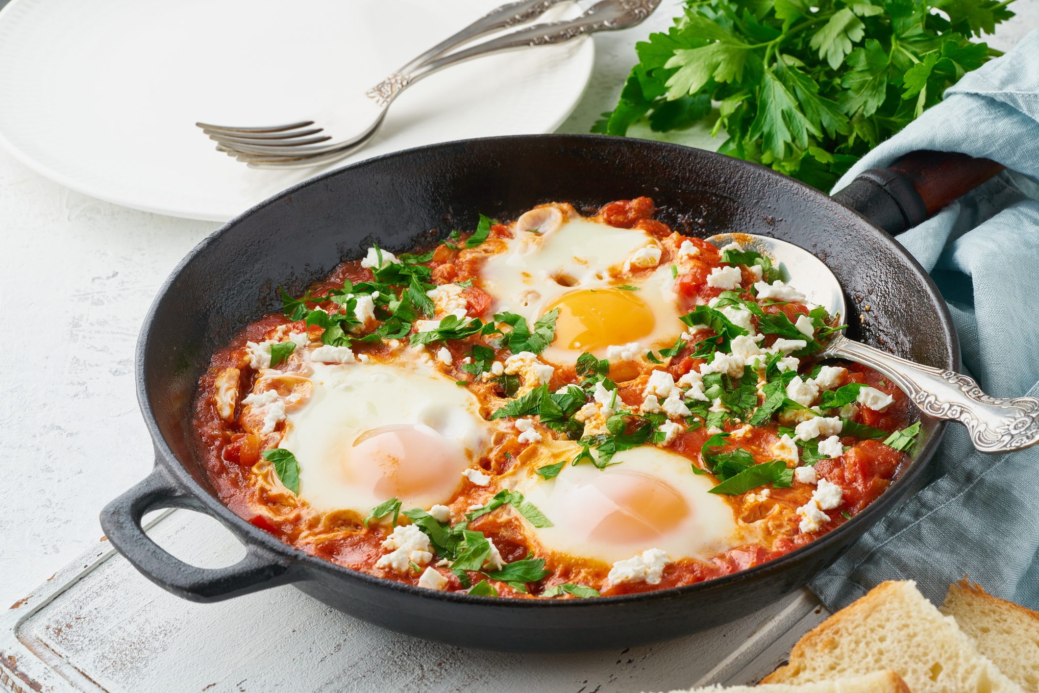 Shakshouka, eggs poached in sauce of tomatoes, olive oil. Mediterranean cuisine.
