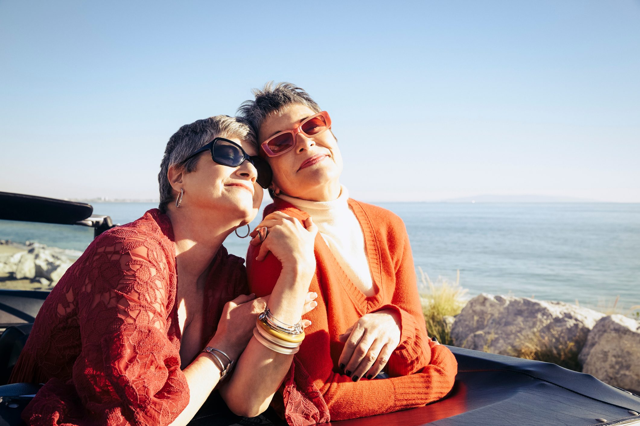 Mature women posing for a photo by the sea