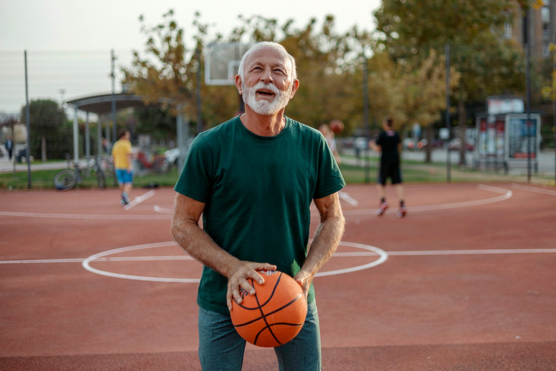One Senior Player on Outdoor Basketball Court